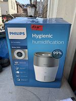 Front view of boxed Philips Series 2000 air humidifier showing branding and product image