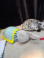 Both plush projector lights side by side on table