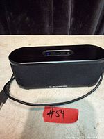 Front view of Scosche BoomStream speaker showing grille and logo