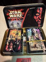 Open tin showing both playing card decks and lid artwork