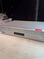 Front view showing VHS slot, DVD tray and controls