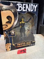 Front view of sealed Twisted Alice action figure box showing branding and figure