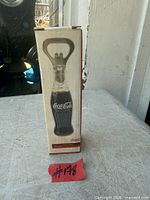 Front view of boxed Coca-Cola bottle opener