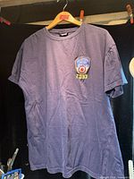 Front view of navy FDNY t-shirt on hanger