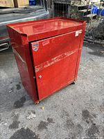 full exterior of red metal tool cabinet on casters