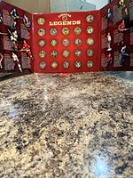 Tri-fold display open showing full medallion set