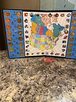 Entire tri-fold set open showing medals, map and team logos