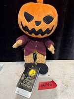 Front view of Pumpkin King Jack Skellington plush showing hang tag