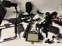 Assortment overview showing all microphones, LED panel, rigs, wireless units and cables
