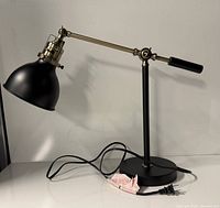 Full view of lamp showing shade, arm, base and cord