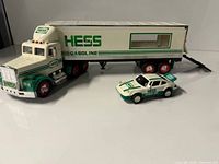 Tractor-trailer and race car displayed with ramp down