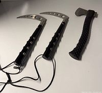 Overview of two kama and one hatchet on surface