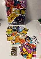 Full lot showing sealed calendar, spread of trading cards, gold Mewtwo card, envelopes