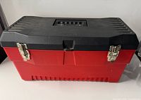 Front view of red base black lid toolbox showing metal latches