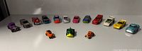 All sixteen Hot Wheels vehicles in semicircle showing variety