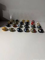 All 23 mini helmets front view