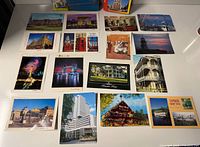 Overview of seventeen loose postcards arranged on table