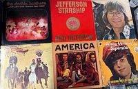 Front covers of six LPs including Doobie Brothers, Jefferson Starship, John Denver, America, Donny Osmond