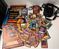 Pile of Yu-Gi-Oh! cards, Shonen Jump promo, pouch, carrying case
