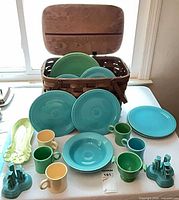 Overall view of dinnerware spread and basket