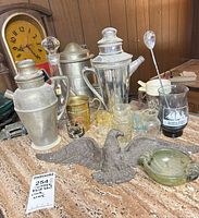 Group shot showing entirety of barware, glassware, clock, decorative pieces