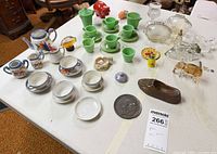 Overall lot showing both tea sets, figurines, souvenirs and tokens