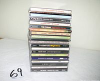 Stack of 19 CD jewel cases, spines legible for majority of titles