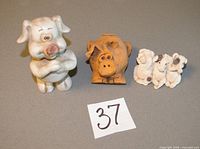 Front view of all three pig figurines