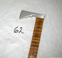 Close view of aluminum hatchet-style head and top of wood shaft