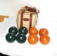Full set laid out: eight bocce balls, pallino, carrying bag