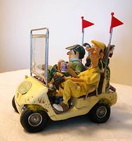 Front three-quarter view of resin golf-cart sculpture