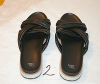 Top view of both flip-flops showing crisscross straps and branding on footbeds