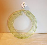 Full view of circular wire coil bird feeder, light green