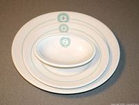 Three Shenango China pieces stacked showing crest and size comparison