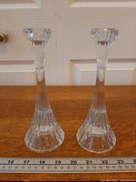 Front view of pair of Mikasa Park Lane crystal candlestick holders with ruler showing height