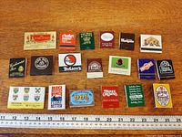 All 18 matchbooks laid out with ruler for scale