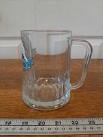 Full profile of glass mug showing handle and faceted base