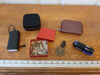 All items laid out with ruler for scale