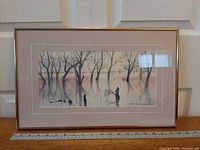 Full view of framed watercolor with ruler for scale