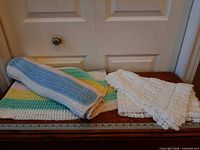 Both crochet baby blankets laid flat