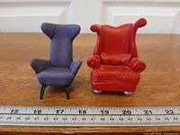 Front view of both miniature chairs beside ruler for scale