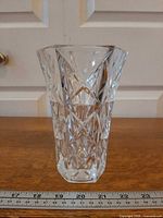 Front view of hexagonal crystal bud vase with diamond pattern, ruler for scale