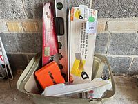 Overall view of tote showing bit set, level, mitre box with saw, Husky package