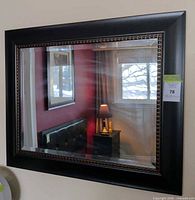 Front view of rectangular mirror showing frame and reflection