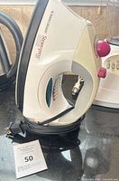 Left side view of Black & Decker SteamPress iron showing model marking, control knob, soleplate and cord