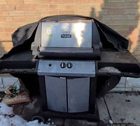 Front view of Broil-Mate grill with cover draped