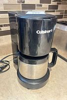 Front view of Cuisinart black coffee maker with stainless carafe