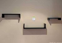 Three floating shelves mounted on wall