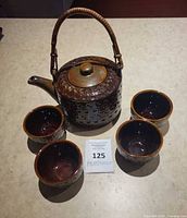 Teapot and four cups full view