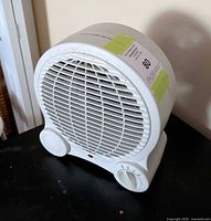 Front view showing grille, dials, indicator light, model label